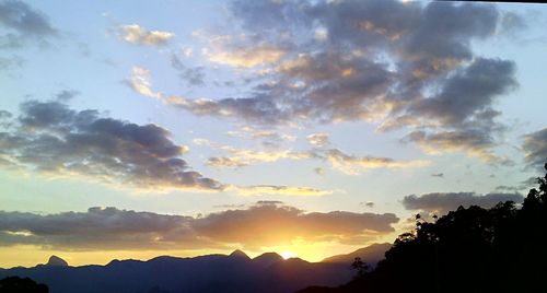 Scenic view of mountains against sky at sunset