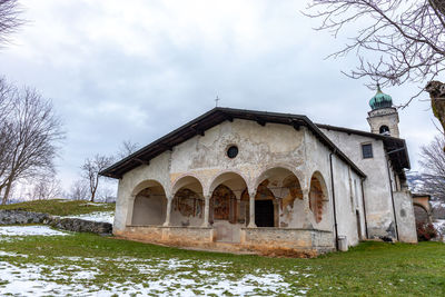 Church by building against sky