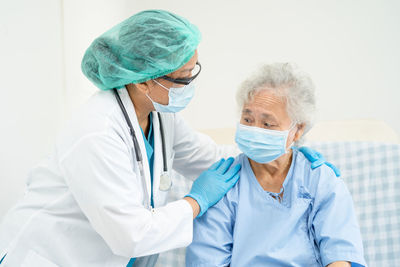 Female doctor holding medicine at clinic