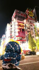 Woman standing in city at night