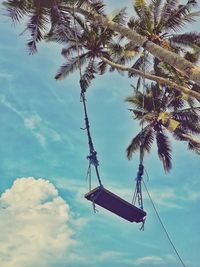 Low angle view of coconut palm tree against sky