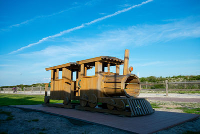 Built structure on field against blue sky