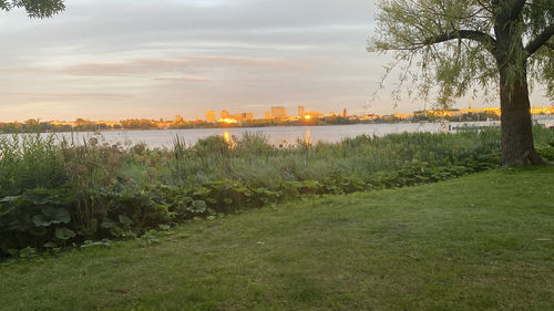 Scenic view of river against sky during sunset