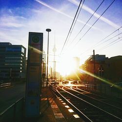 Railroad tracks in city against sky