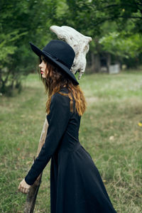 Rear view of woman standing on field