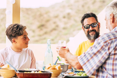 Father and daughter sitting on table