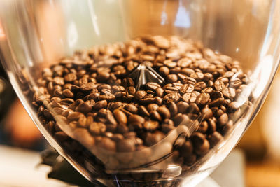 Close-up of coffee beans in glass on table