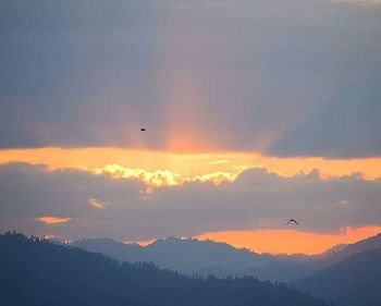 Scenic view of sunset over mountains