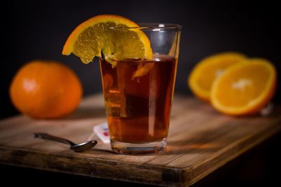 Glass of orange juice on table