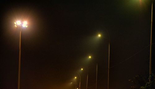 Low angle view of illuminated lights at night