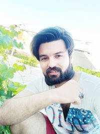 Portrait of young man sitting outdoors