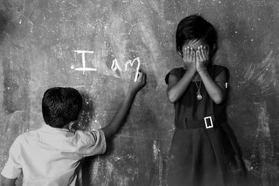 Portrait of boy standing with text