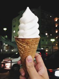 Close-up of hand holding ice cream cone