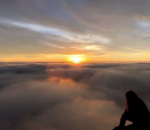 Silhouette man looking at sunset