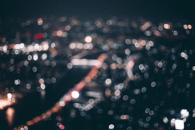 Defocused image of illuminated city at night