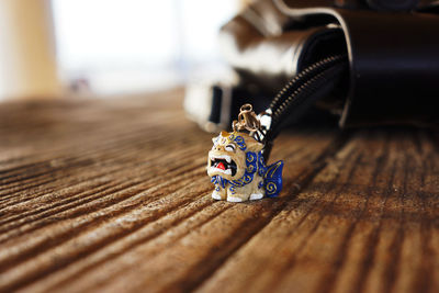 Close-up of key ring with bag on wooden table