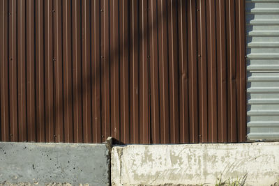 Fence around construction fence made of metal profile. brown steel profile. private territory.