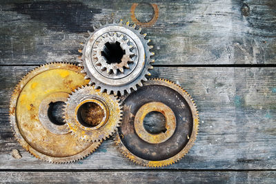 High angle view shot of rusty gears on wooden table