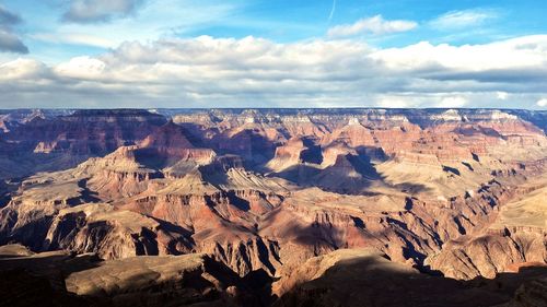 Scenic view of dramatic landscape against cloudy sky