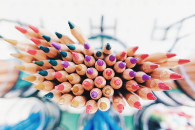 Close-up of hand holding colored pencils