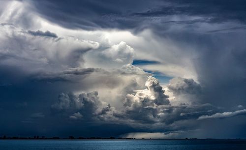 Scenic view of sea against storm clouds