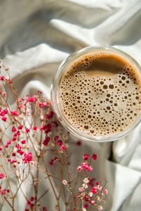 Cup of latte cappuccino. morning coffee aesthetics vibes. breakfast. pink gypsophila flowers hard 