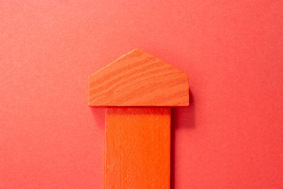 Directly above shot of orange colored pencils against red background