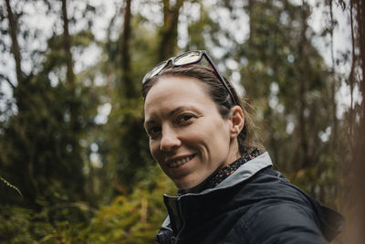 Portrait of smiling mid adult man in forest