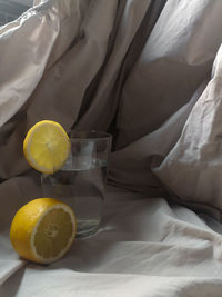 High angle view of fruits in glass on bed