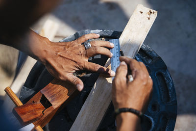 Cropped hands of carpenter working in workshop
