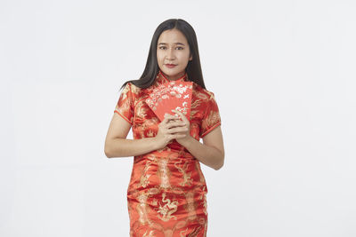 Woman standing against white background