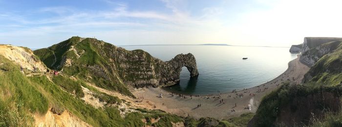 Panoramic view of sea and mountains against sky