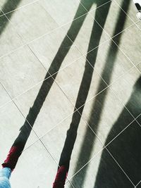 Low section of person shadow on floor