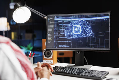 Midsection of woman using laptop