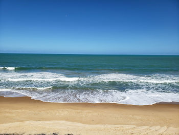 Ocean waves breaking on the beach sand located in northeastern brazil