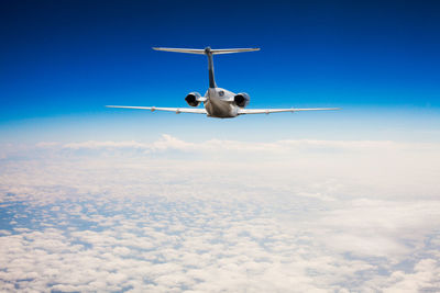 Low angle view of airplane flying in sky