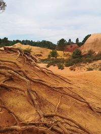 Scenic view of arid landscape against sky