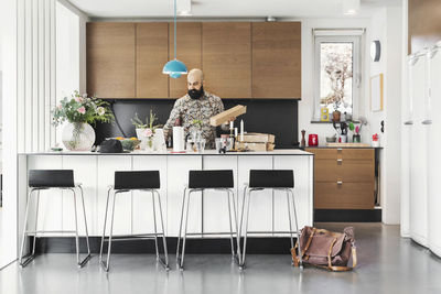 Male architect working at kitchen island