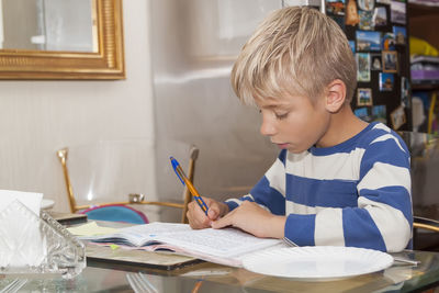 Boy sitting on table