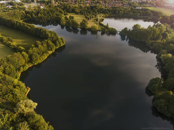 High angle view of river amidst trees against sky