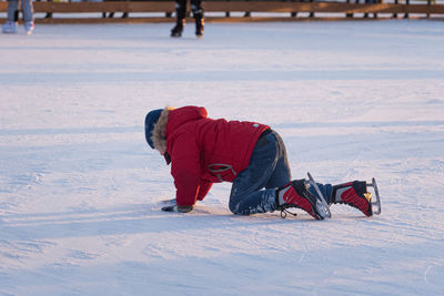 Full length of man lying on snow covered land