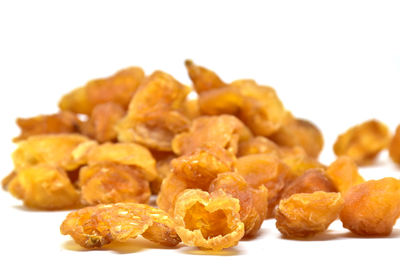 Close-up of food in plate against white background