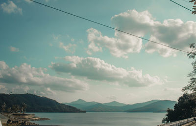 Low angle view of mountains and sea against sky