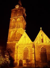 Low angle view of bell tower against sky at night