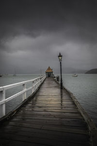 Pier over sea against sky at dusk