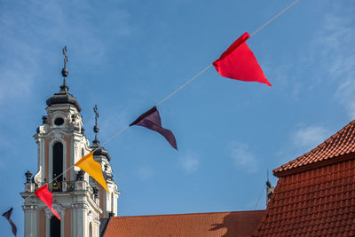 Low angle view of colorful bunting against blue sky