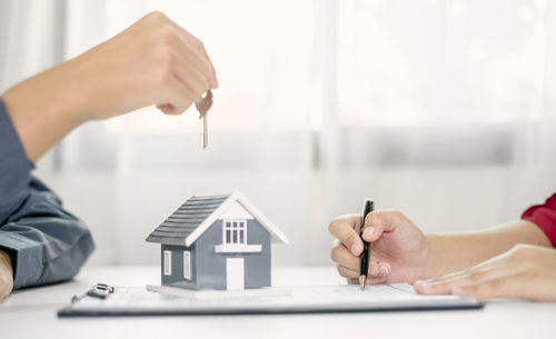 Midsection of business colleagues working on table