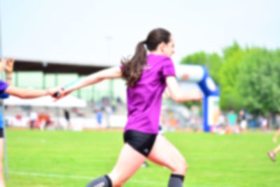 Woman playing soccer on field