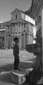 Man standing by statue against sky