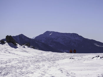 Scenic view of snow covered mountains against clear sky